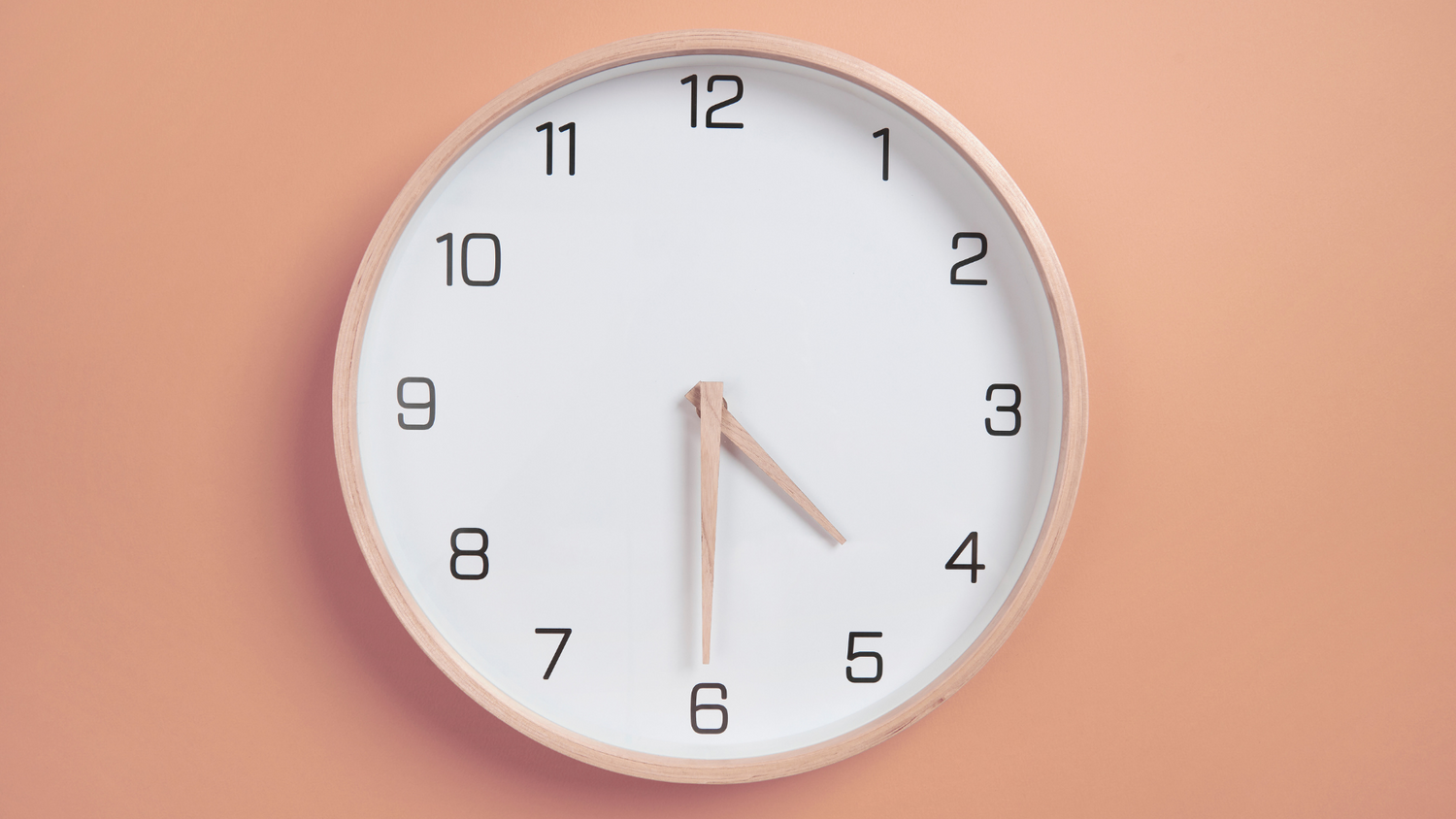 Wall clock on a peach-colored background