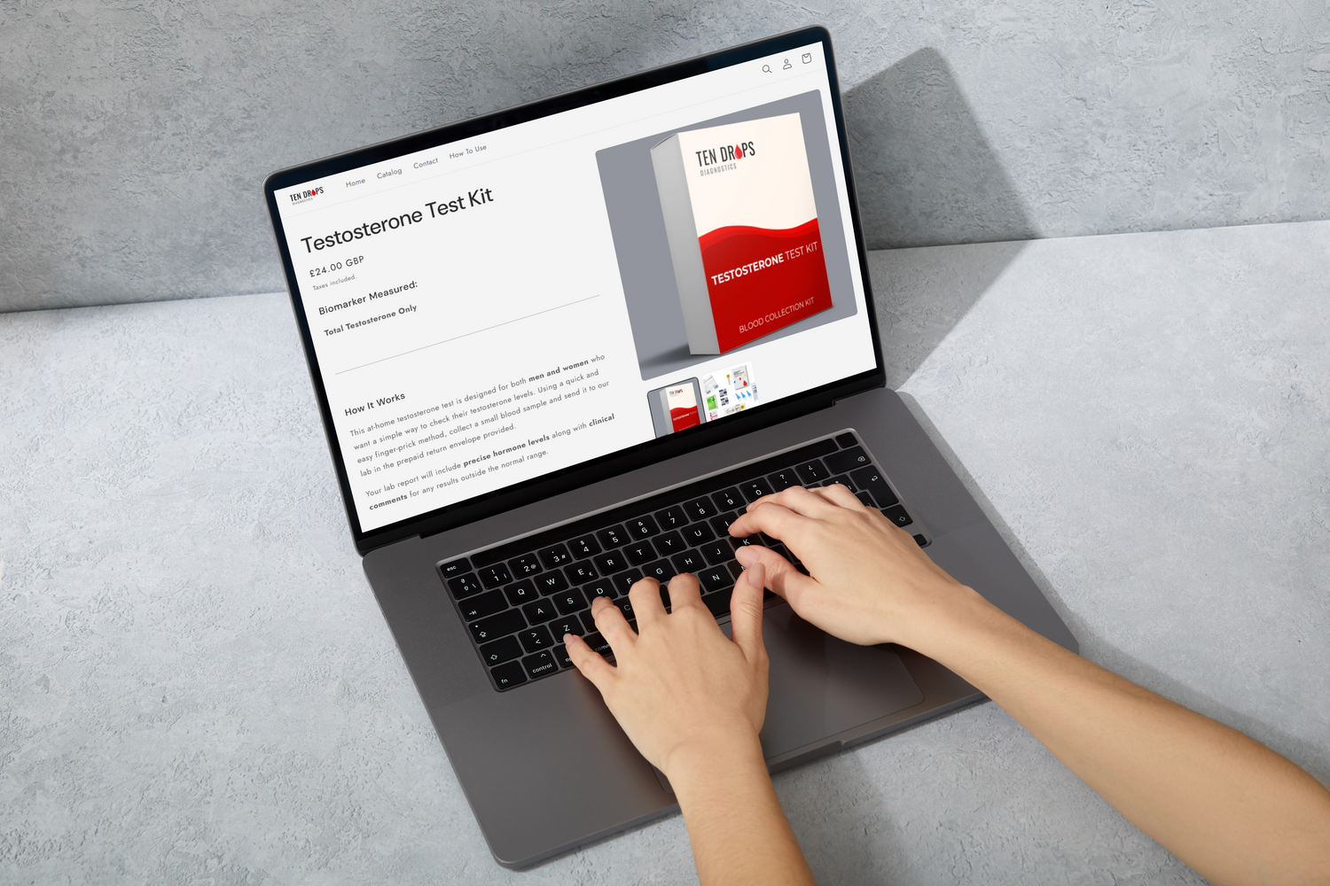 Person using a laptop ordering a test kit on a gray surface